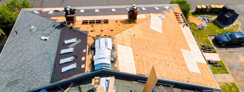 While repairing roof apartment building, old shingles replaced plywood and new shingles were installed.